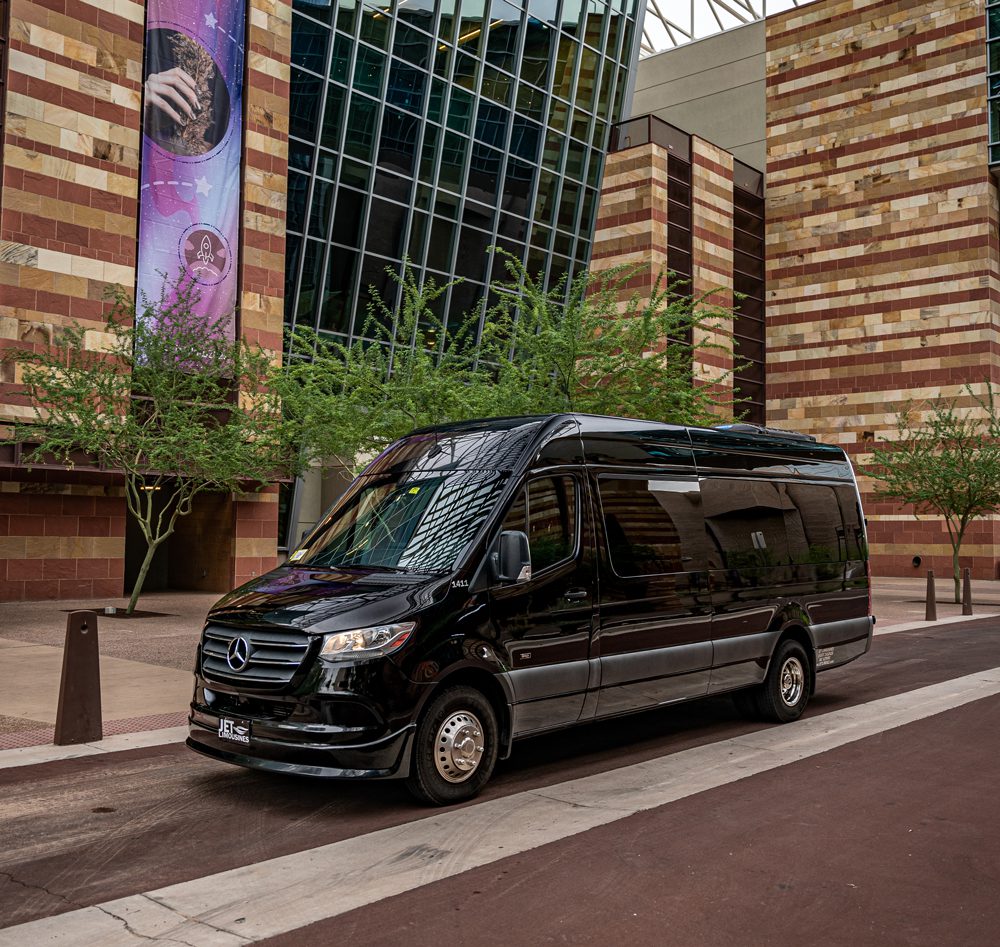 A black van parked on the side of a road.