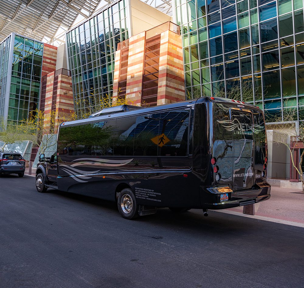 A black van parked in front of a building.