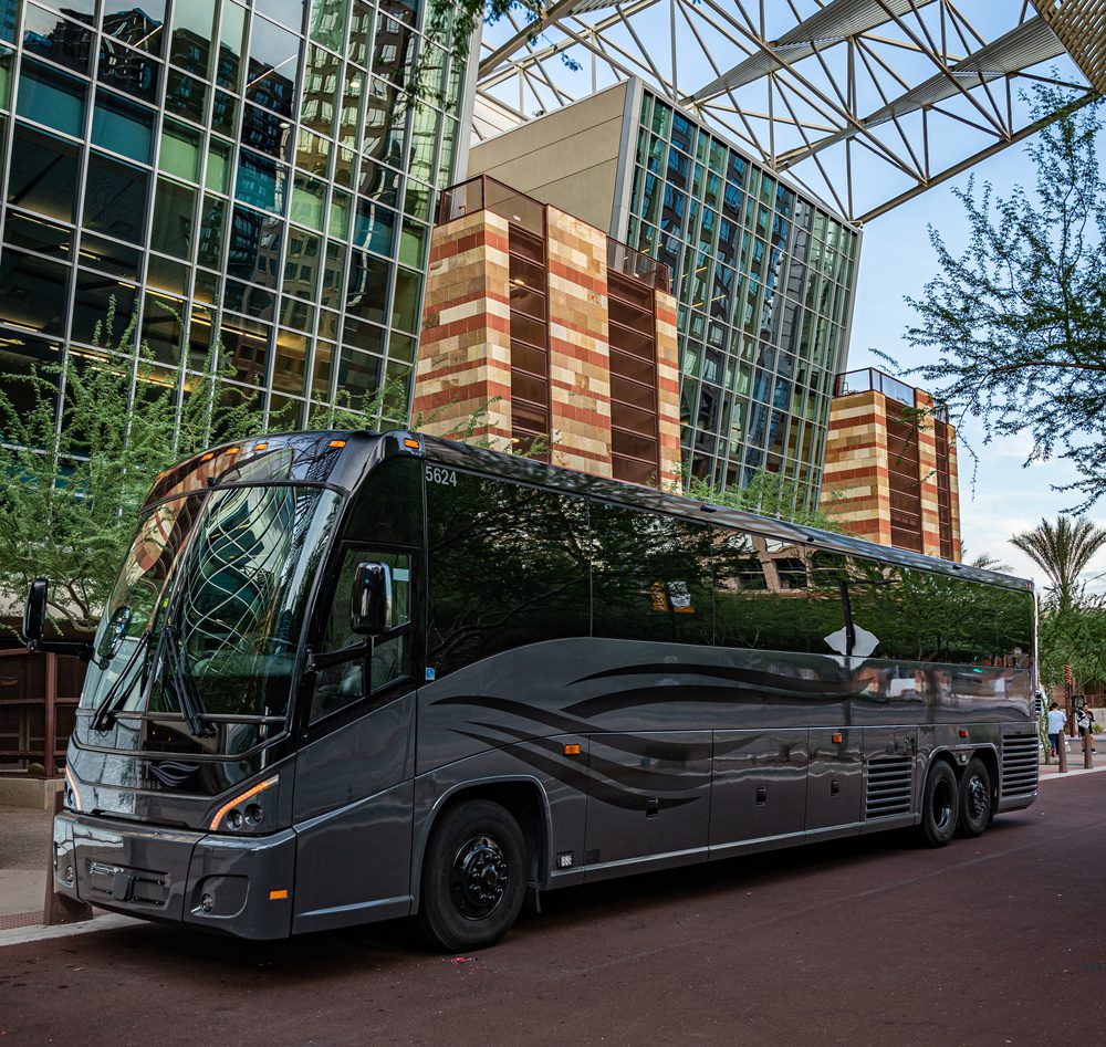 A black bus parked in front of a building.